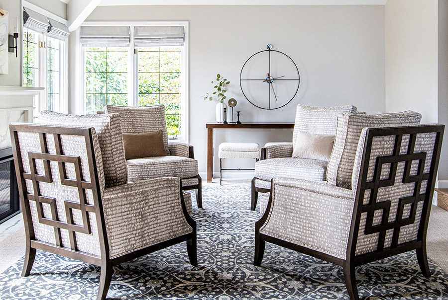 Focused redesigned contemporary style living room with four relaxed modern chairs. Large windows allowing for natural light.