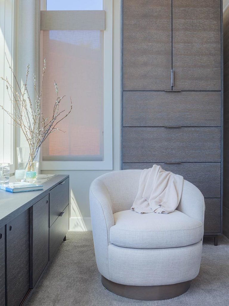 Modern splendor style bedroom with a classic swivel chair in the corner.