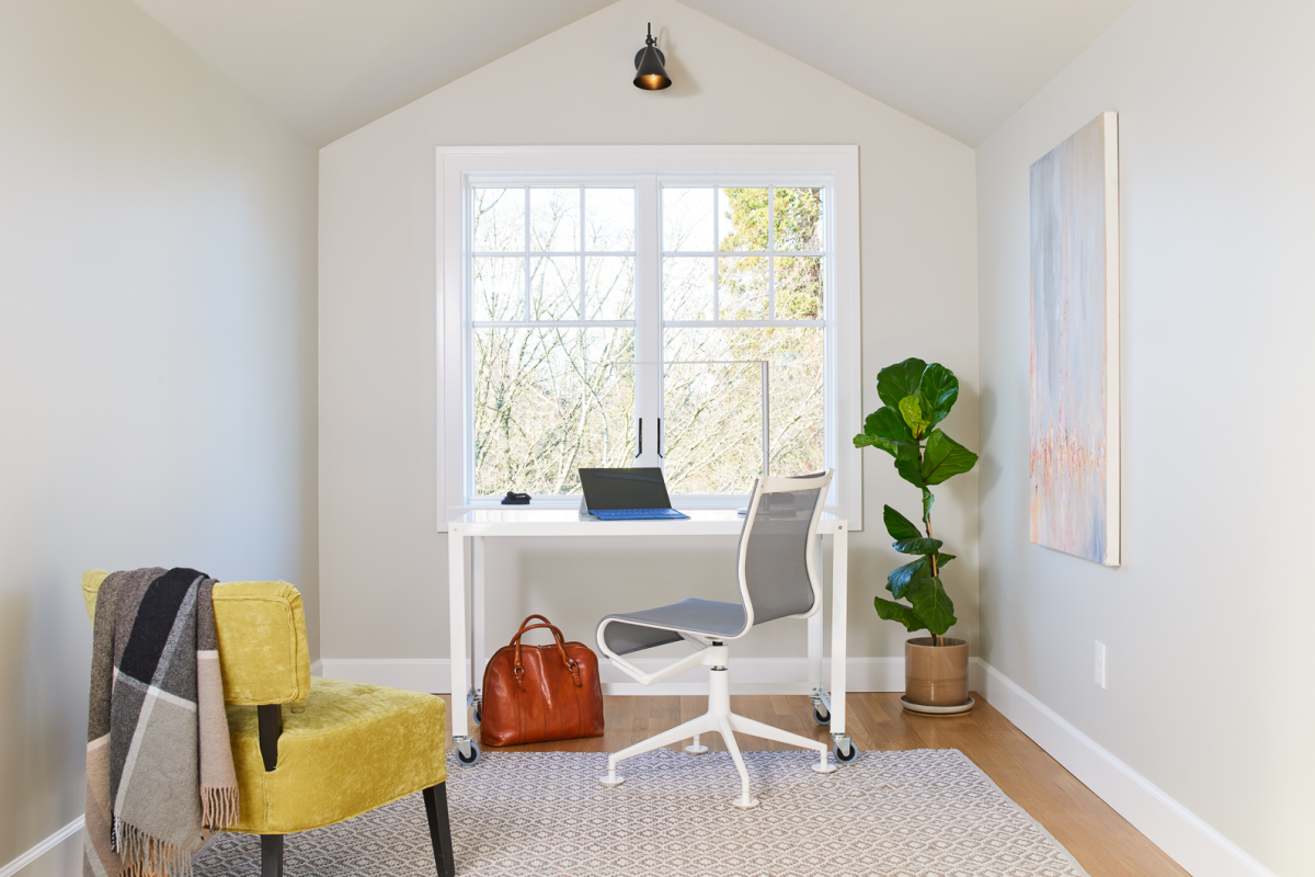 Light-filled attic office with modern decor — small space solutions and full service design